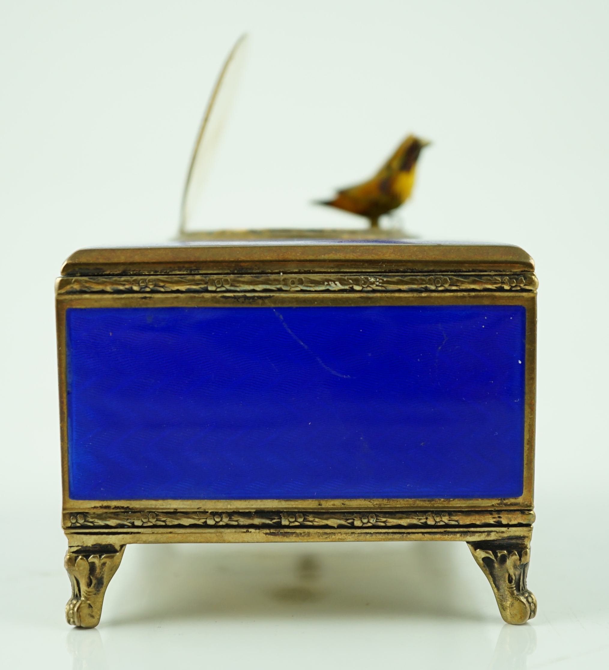 An early 20th century sterling silver gilt and blue guilloche enamelled rectangular singing bird box